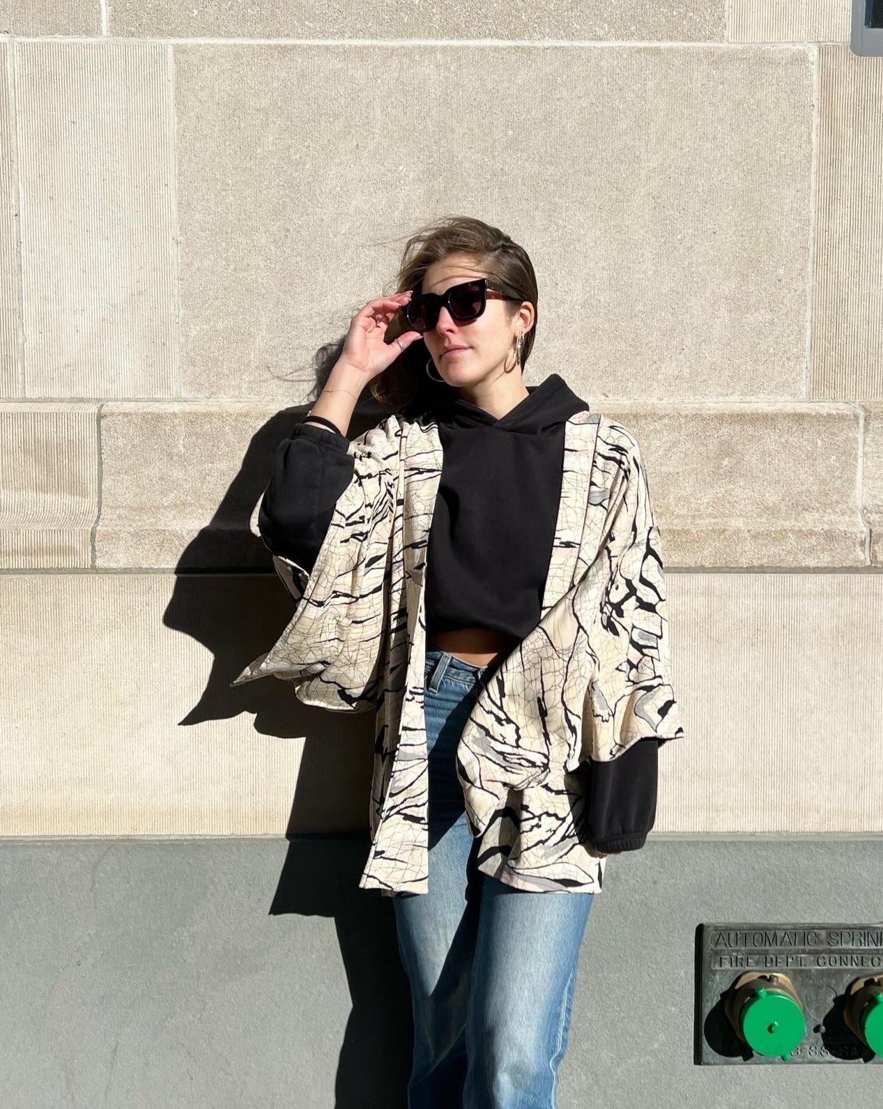 woman wearing a hoari jacket with denim jeans
